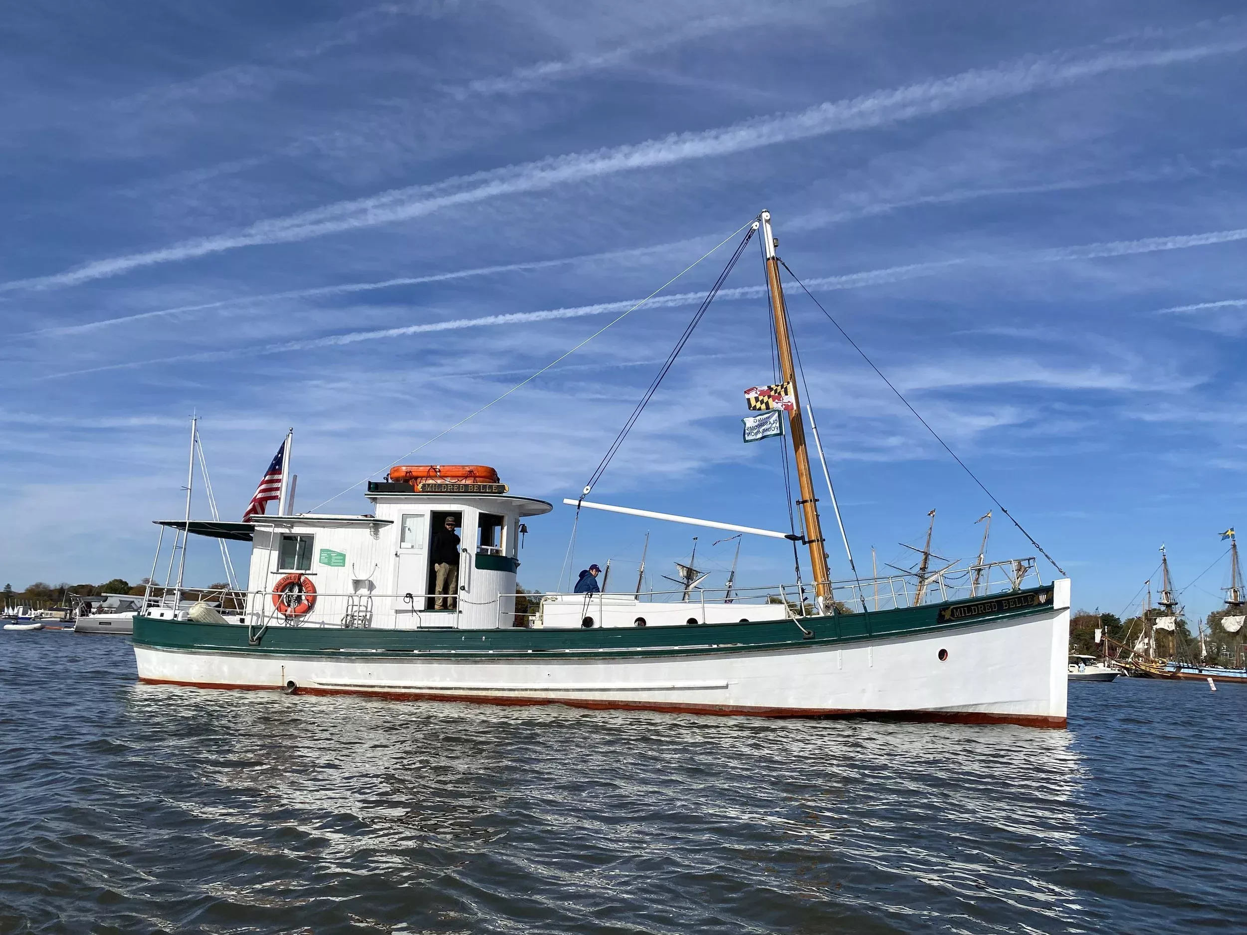 A historic white boat, the Mildred Belle, on the waters of National Harbor.
